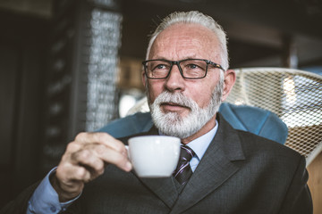 Senor businessman drinking coffee. Relax time.