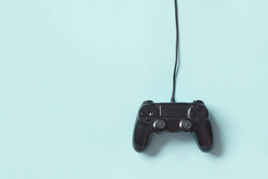 Gamepad connected wire from the game console on blue background.