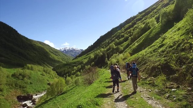 Young group hiking and chatting in the Georgian mountains.