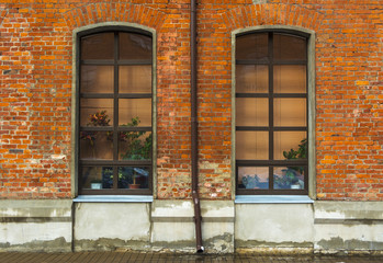Fototapeta na wymiar Two tall Windows in a brick wall