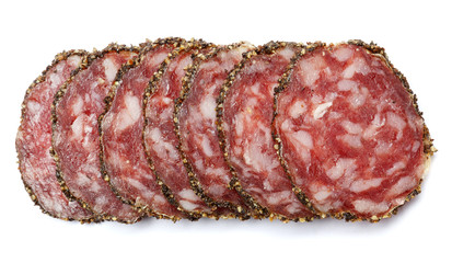 Dried organic salami sausage covered with pepper on white background