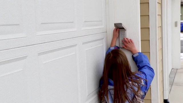 young girl coming home from school and gettting in her house using a garage keypad