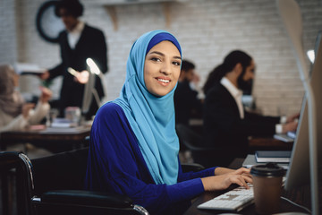 Woman in wheelchair working in office