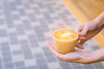 beautiful girl hold delicious hot coffee cup serving for your freshness.