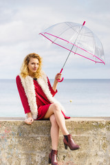 Woman having fun outdoor with umbrella