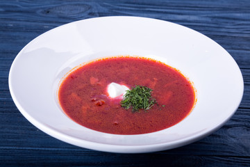 Red borsch in a white plate