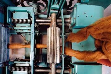 Old combing machine alpaca wool with skeins raw fiber viewed from above