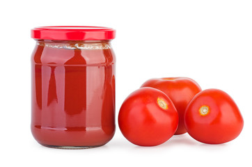 Glass jar with tomato paste and tomatoes