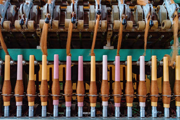 Old wool spinning machine with alpaca fiber spindles