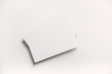 Blank business cards on paper background. Mockup for branding identity. Studio shot.