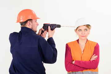 Woman with bored face in helmet ignoring husband annoying her.