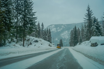 Outdoor view of winter road snow and ice in the forest of Norway
