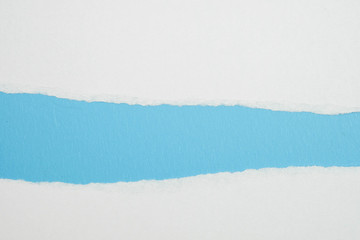 white torn paper with blue background, ready for design