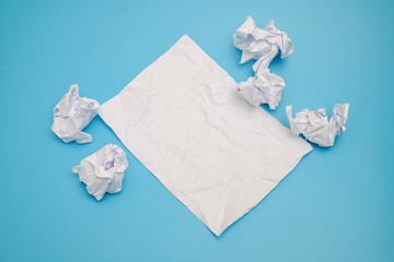 Crumpled paper balls on a blue background