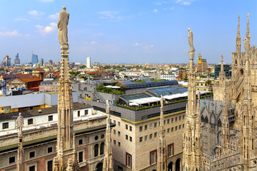 Milan, Italy - Roof architecture of the Cathedral of St. Mary Nascente - Duomo Santa Maria Nascente di Milano at Piazza del Duomo - Cathedral Square and Panoramic view of Milan from cathedral roof