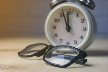 glasses and alarm clock