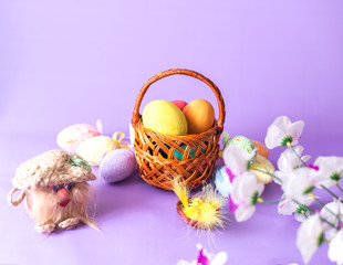 Easter eggs in a basket on a wooden background