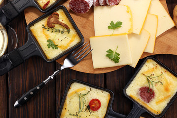 Delicious traditional Swiss melted raclette cheese on diced boiled or baked potato.