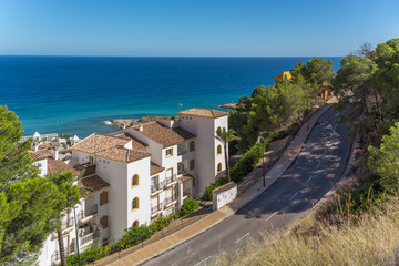 Fototapeta na wymiar Street along the sea with white houses. Spain