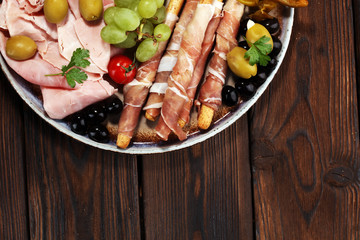Italian antipasti wine snacks set. Cheese variety, Mediterranean olives, pickles, Prosciutto di...