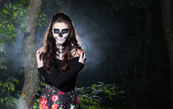 Beautiful and scary devil. Devil woman in halloween concept. Halloween make up sugar skull beautiful model.