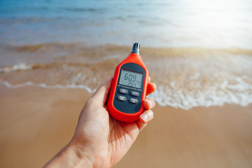 portable thermometer in hand measuring outdoor air temperature and humidity © nikkytok
