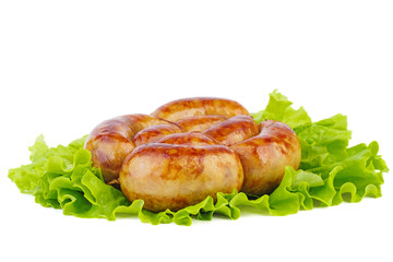 Grilled homemade sausage over fresh lettuce leaf
