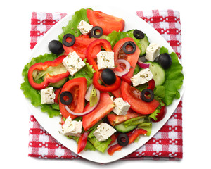 Square plate of greek salad isolated on white. fresh vegetable salad top view