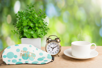 Flower, alarm clock and coffee cup. Morning background
