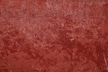 closeup of a red wall with distressed weathered appearance, for backgrounds