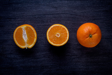  useful vitaminized food with vitamin c, whole and cut oranges are on the table