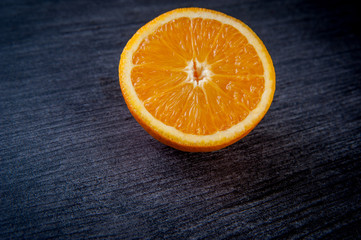  useful vitaminized food with vitamin c, whole and cut oranges are on the table