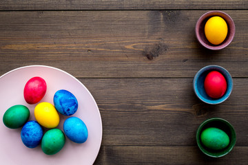Easter celebration with colorful eggs. Wooden background top view mock up