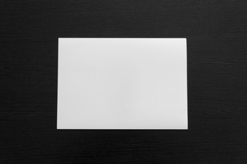 White list on a wooden table. Background and mock-up