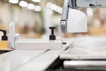 production, manufacture and woodworking industry concept - sliding panel saw at workshop