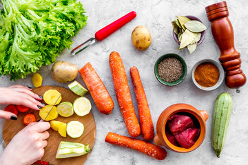 ingredients for vegetable ragout cooking on stone table background top view