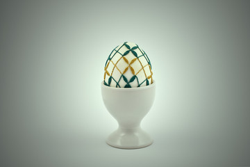 Decorated easter egg stock images. Spring decoration images. Simple ceramic egg stand. Crocheted Easter Egg