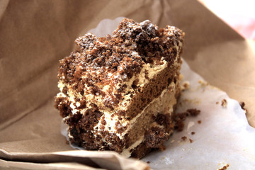 Delicious sour cream-honey cake from a confectioner's shop. Dark and light biscuit