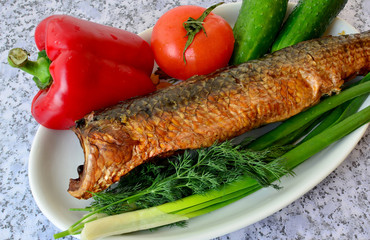 Beautiful still life from fish in a frame of vegetables.
