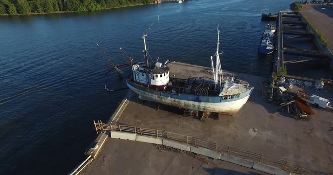 4K aerial view drone footage of Helsinki Baltic Sea lagoon area and remains of sunken ship and boats in summer evening, the capital of Finland Suomi, northern Europe