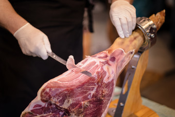 A front leg of Serrano ham also known as Spanish Iberian ham or Pata Negra mounted on a wooden...