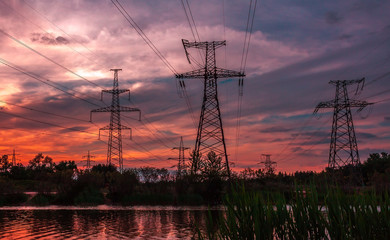 Fototapeta premium high-voltage power lines at sunset.