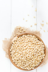 Shelled Raw Pine Nuts in the Wooden Bowl