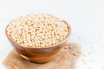 Shelled Raw Pine Nuts in the Wooden Bowl