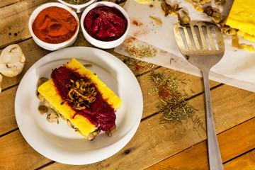 Tasty polenta with mushrooms and tomatoes.
