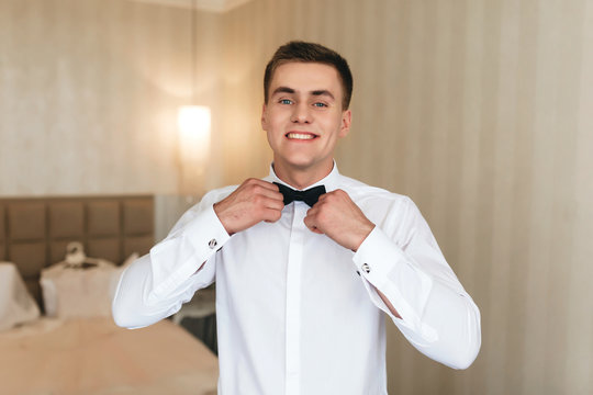Smiling man with black bow tie