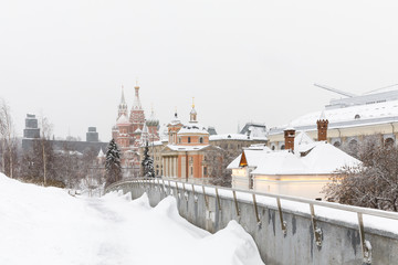 Heavy snowfall in Moscow. Snow-covered roads and Zaryadye Park with a view of the Kremlin and St. Basil's Cathedral