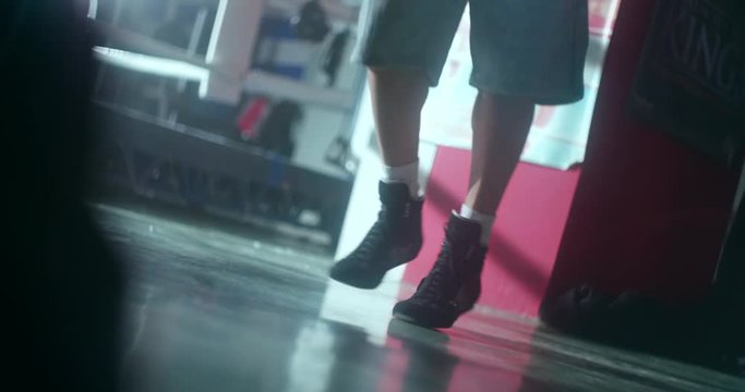 Young man's feet skipping a jump rope indoors