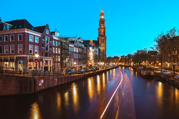 Fototapeta na wymiar he Westerkerk Western Church along the Prinsengracht canal in Amsterdam at night