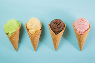 Selection of colorful ice cream scoops on blue background
